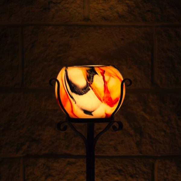 The drama of a Black and Orange lantern enhances any setting. Photo by Integrity Candles