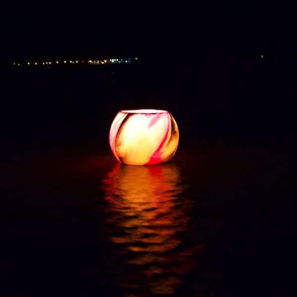 Lanterns floating in water create a unique function decoration. Photo by Frank Gumley