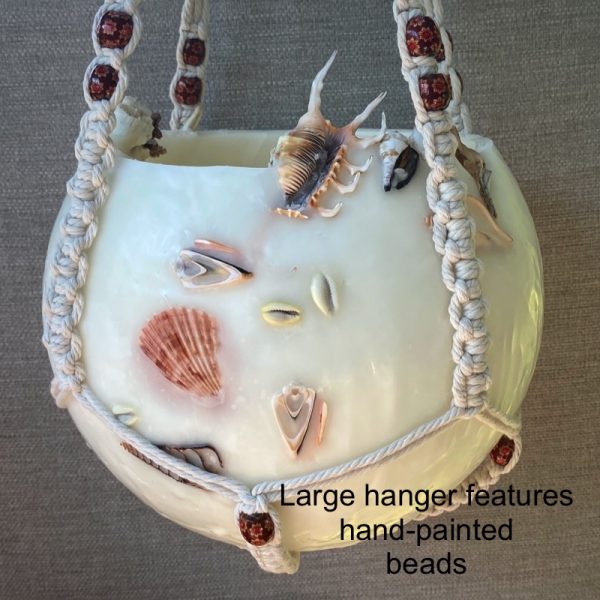 The large macrame hanger features hand painted beads.