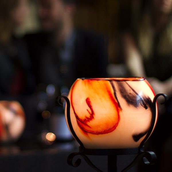 Dress your table around a bright lantern in a hand-made steel stand. Photo by Integrity Candles.