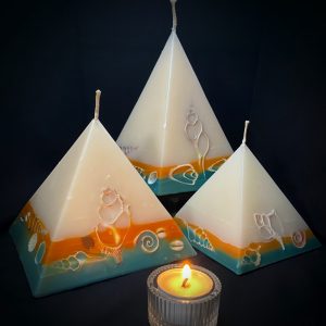 Our Lime and Coconut nest of pyramids combined burn time is over 440 hours. This tropically scented candle range is infused with essential oils of lime and coconut. White in colour, these candles feature an orange and blue banded base embedded with sea shells. As you near the end of your candle's burning, the trove of exotic shells is revealed - your lasting keepsake.