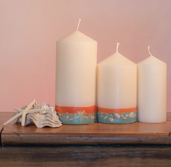 This tropically scented candle range is infused with essential oils of Lime and Coconut. White in colour, these candles feature an orange and blue banded base embedded with sea shells.