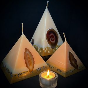 Our Vanilla nest of pyramids combined burn time is over 440 hours. As your pyramid candle burns, the flame illuminates the Agate, revealing the stone's unique variegated patterns, and leaves you with a gorgeous keepsake. Coloured in hues of cream and dusky brown and infused with Vanilla oil, this candle further features a variegated coloured base embedded with Agate Crystal slices and river pebbles.